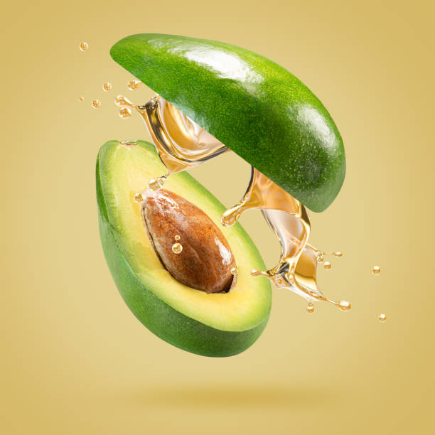 istock avocado with oil splash on a light green background 2160808150