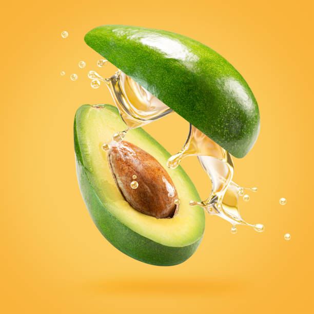 istock avocado with oil splash on a light green background 2160808401