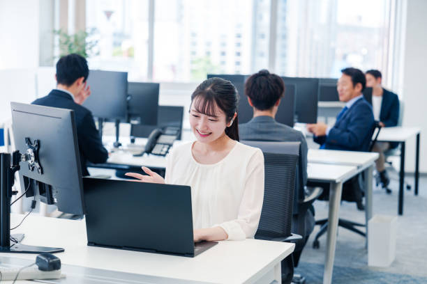 istock Woman using wireless earphones for remote meeting in office 2160809280