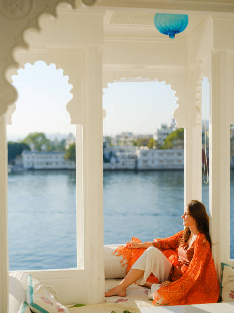 istock Woman sitting on balcony  during trip to Udaipur 2160811463