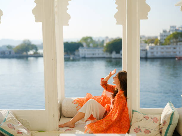 istock Woman sitting on balcony  during trip to Udaipur 2160811469