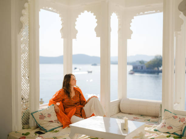 Woman sitting on balcony  during trip to Udaipur