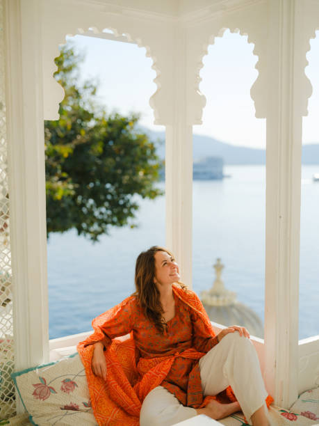 istock Woman sitting on balcony  during trip to Udaipur 2160811512