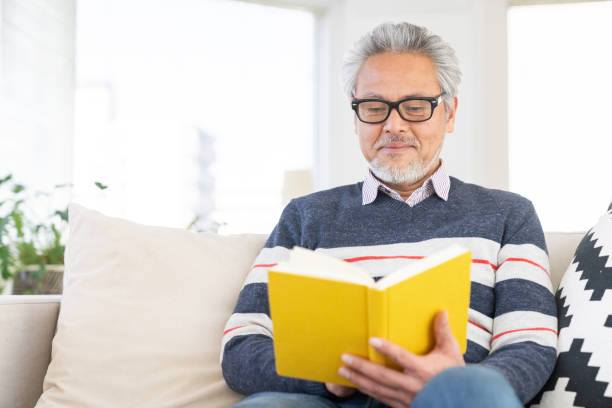 istock elderly man who reads a book, 2160815362