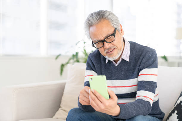 istock elderly man who uses smart phone,think 2160815434
