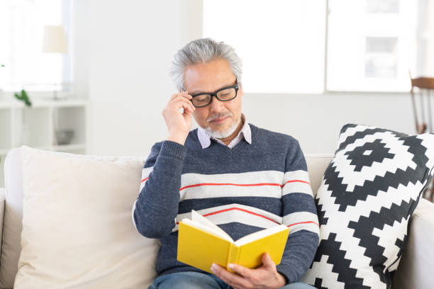 Asian elderly man who reads a book,