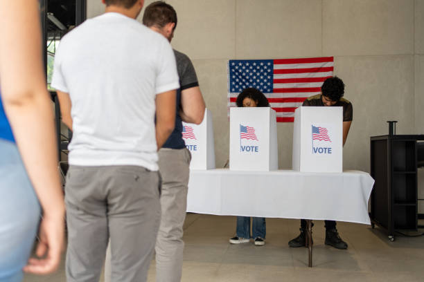 istock people waiting in line queue for voting registration in the US election polling place 2160817722