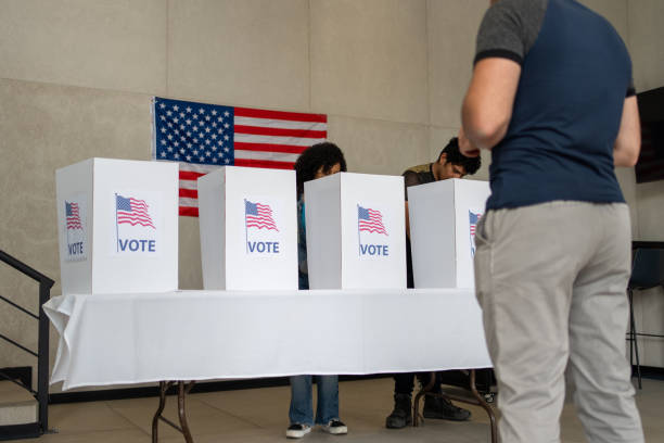 istock people waiting in line queue for voting registration in the US election polling place 2160817954
