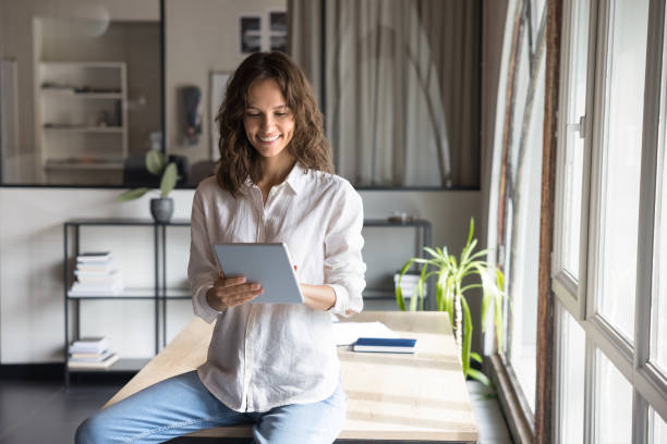 istock Cheerful young entrepreneur woman using business financial application 2160821618