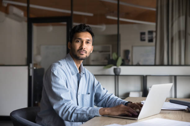 istock Confident handsome young Indian entrepreneur man working at computer 2160822738