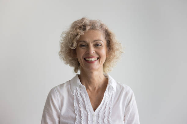 istock Beautiful blond curly-haired mature woman posing in studio 2160824967