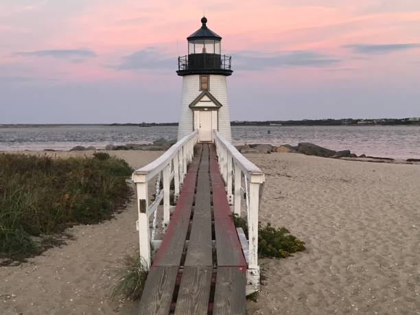 istock Lighthouse at sunset on the beach 2160833899
