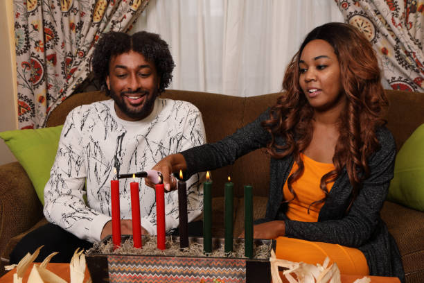 istock Kwanzaa Young Couple She Lights Horizontal 2160835040