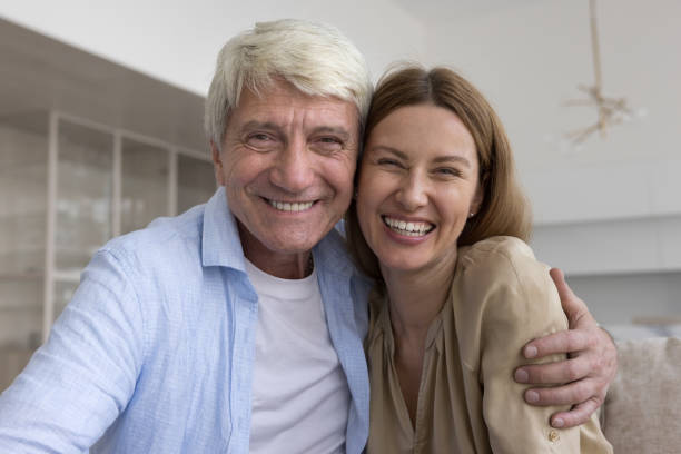 istock Happy retired man hugging his daughter laughing staring at camera 2160836516
