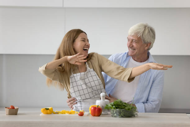 istock Dad and daughter having fun while cooking in modern kitchen 2160836958