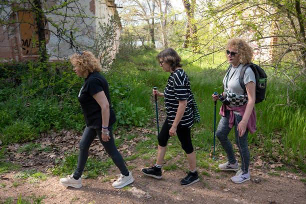 istock Three sister hiking through a forest path near an abandoned house 2160838127
