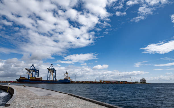 Copenhagen, Denmark - July 5, 2024: Container ship moored at Copenhagen Nordhavn - Northern Harbour. Container cranes ready to load and unload the containers.
