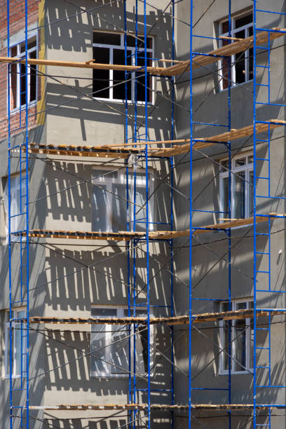 istock Building under construction with scaffolds. The process of renovating building. New construction, exterior wall insulation 2160843593