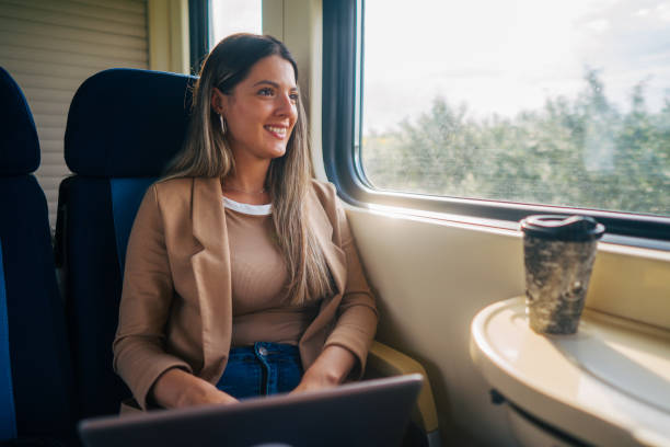 istock young woman travels by train, using lap top 2160844273