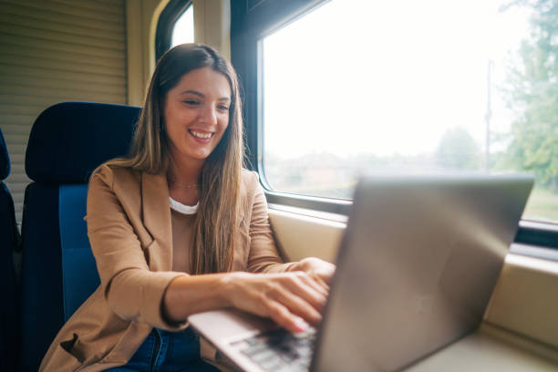 istock young woman travels by train, using lap top 2160844386
