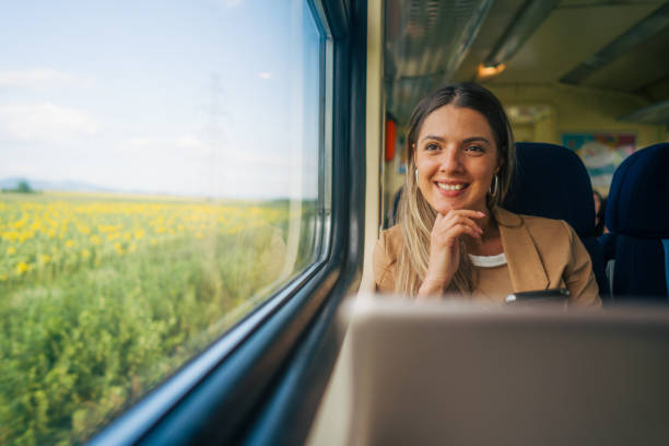 istock young woman travels by train, using lap top and mobile phone 2160844878