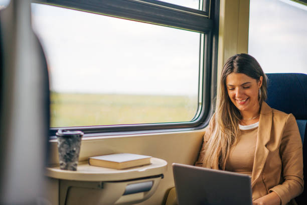istock young woman travels by train, using lap top 2160845402
