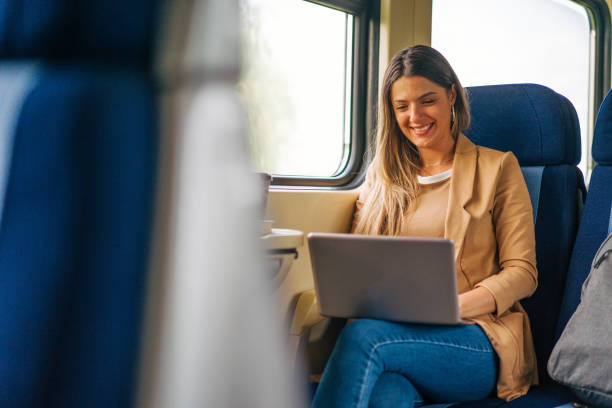 istock young woman travels by train, using lap top 2160845470