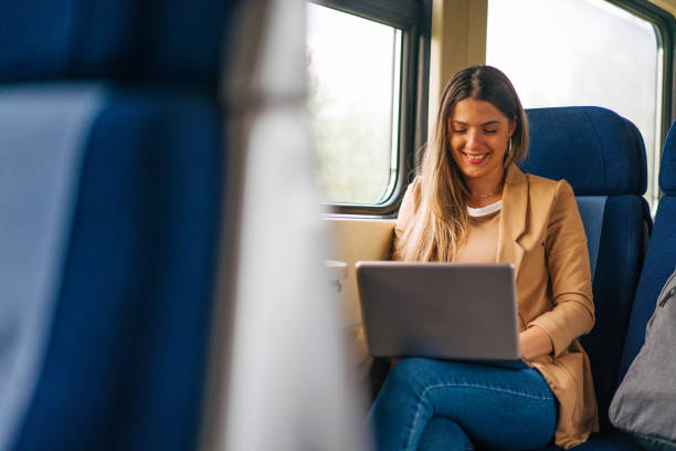 istock young woman travels by train, using lap top 2160846133