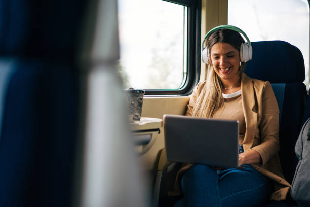 young woman travels by train, using lap top for  video call