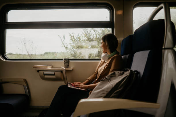 istock young woman travels by train, using lap top 2160846623