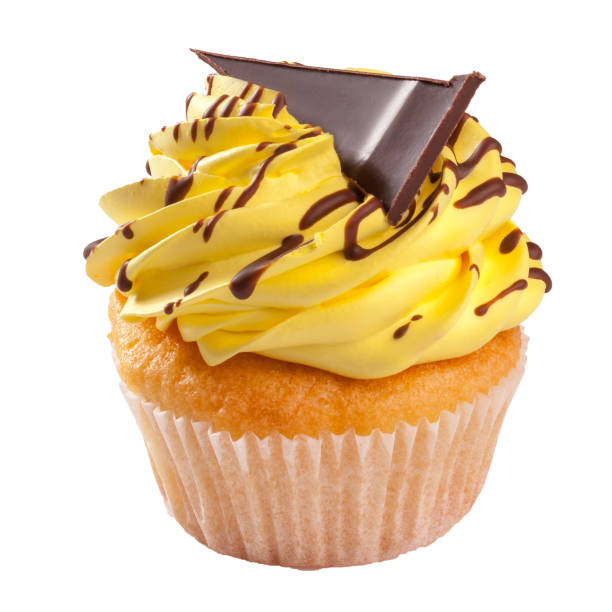 Delicate vanilla cupcake topped with lemon whipped cream frosting decorated with chocolate slice isolated on white background. Popular sweet treats concept