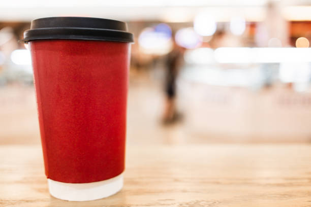 istock Red paper coffee cup mockup with space for text, blurred background 2160847583