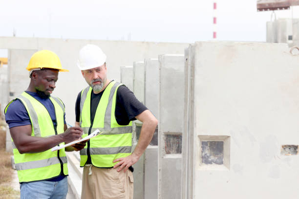 istock Harmony diversity people working together at workplace, senior foreman and African engineer holding document file to inspection at construction site. Workers working together at building site. 2160848473