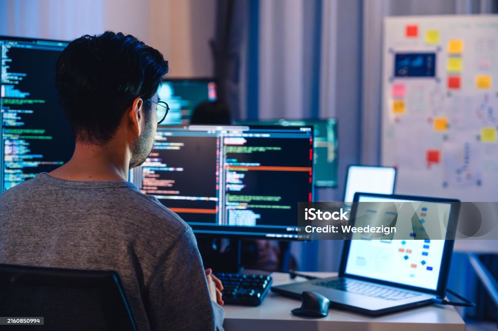 Asian Software Developers Working On Multiple Screens Displaying Code ...