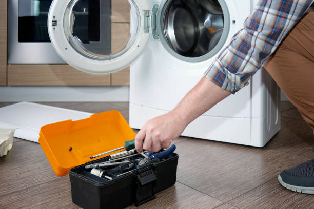 istock A household appliance repairman disassembling a washing machine with a screwdriver. 2160853301