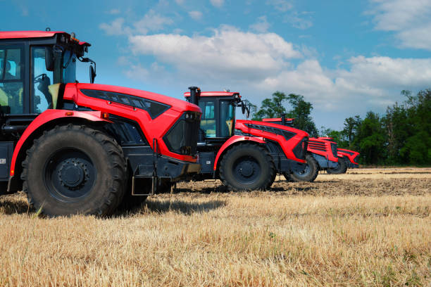 istock Several large modern red tractors standing in a field. 2160853512