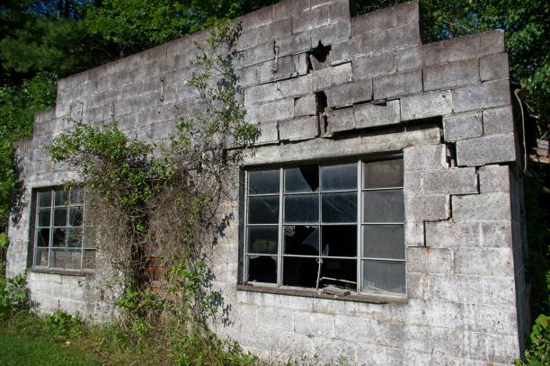istock Old crumbling block building with shattered windows 2160855529