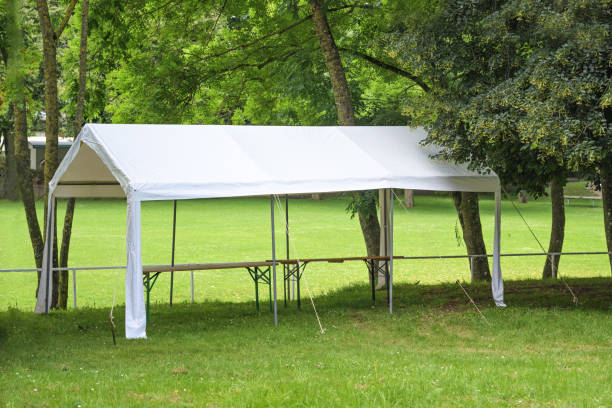 istock Empty white party tent set up under trees on a meadow in a park, preparation for a summer festival event, copy space 2160856153