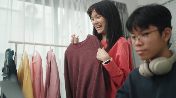 istock Teenagers live-streamed ecommerce sell clothes. 2160856897