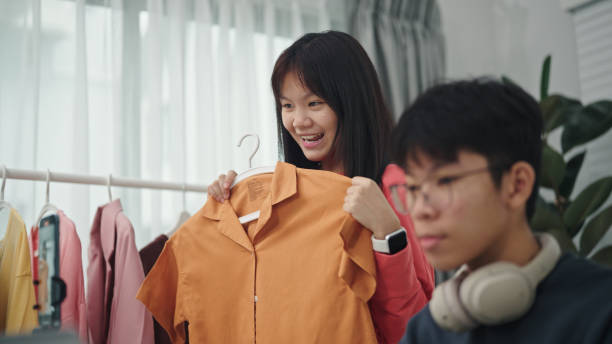 istock Teenagers live-streamed ecommerce sell clothes. 2160856906