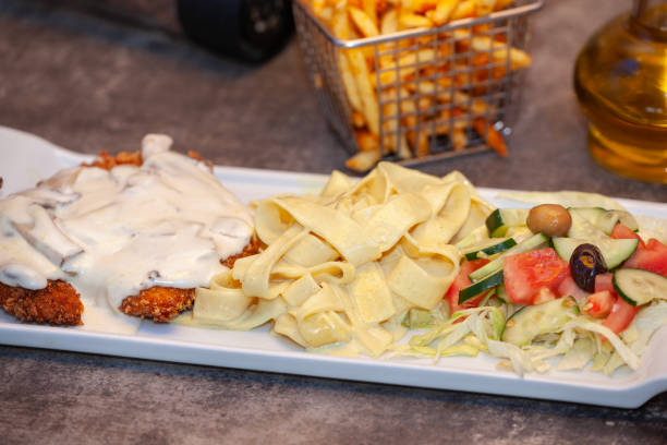 Chicken meat, pasta and salad.