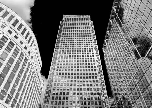 View of modern architecture in the centre of Canary Wharf, London, UK. People an be seen on the promenade