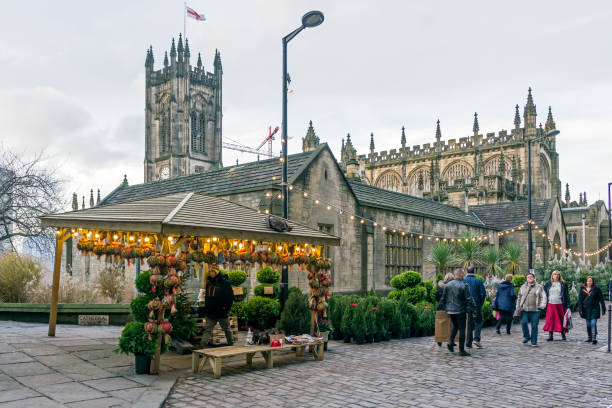 View of Manchester Christmas markets in the centre of Manchester, UK. People an be seen on the promenade