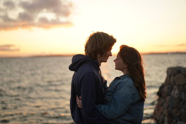 istock young couple enjoying the sea view during sunset 2160859066