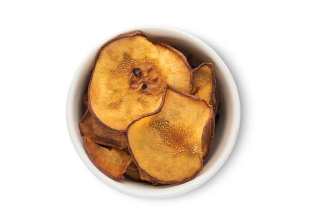 istock Ceramic bowl with sweet dried organic pear circles isolated on white background.Top view. 2160861025