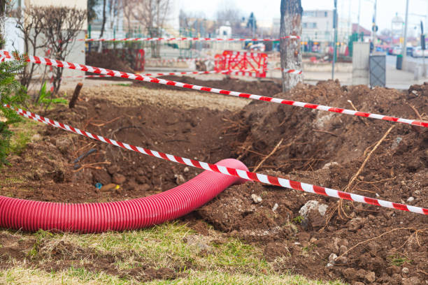 istock Laying communications in the ground using red corrugated hoses. 2160861171