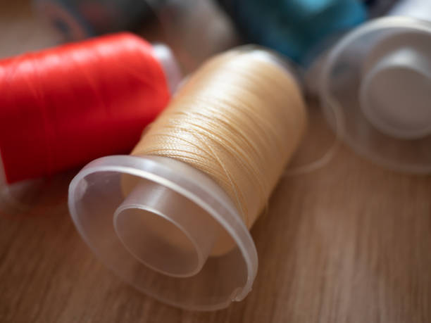 istock Spools of colored embroidery threads. Huge knot is haphazardly b 2160862965