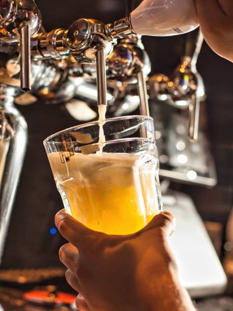 istock Pouring Beer Into Glass At Bar 2160864911