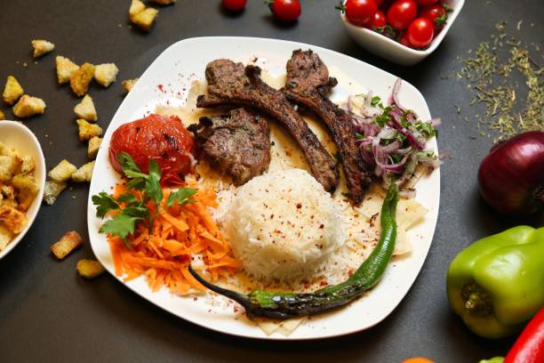istock Grilled Lamb With Rice and Salad on a White Plate 2160865391