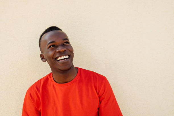 istock Bright Smile: Joyful Young Man in Red Shirt 2160865842